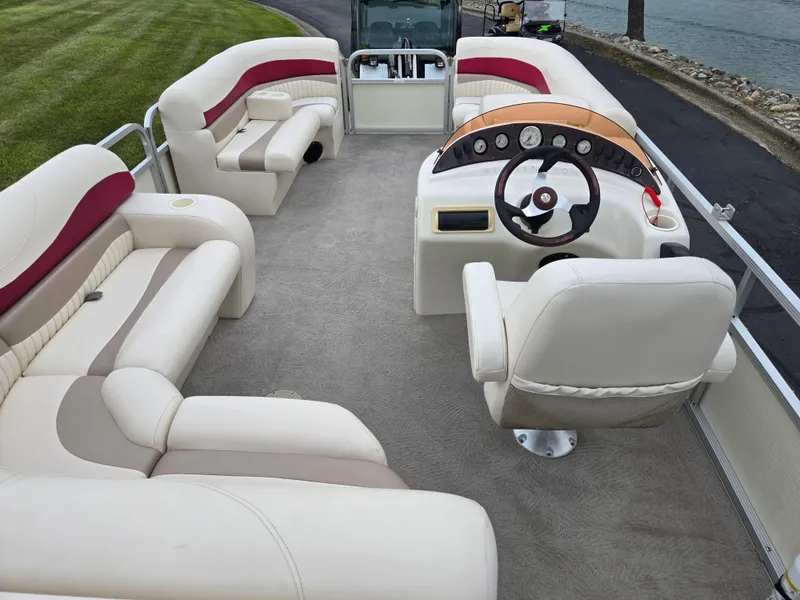 Slide: The Image of 2007 Bennington 2075GL pontoon boat interior with plush seating and steering console. - 18