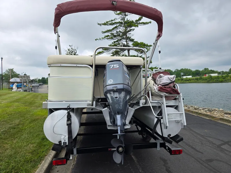 Slide: The Image of 2007 Bennington 2075GL pontoon boat with 75HP motor, parked near a lake. - 2