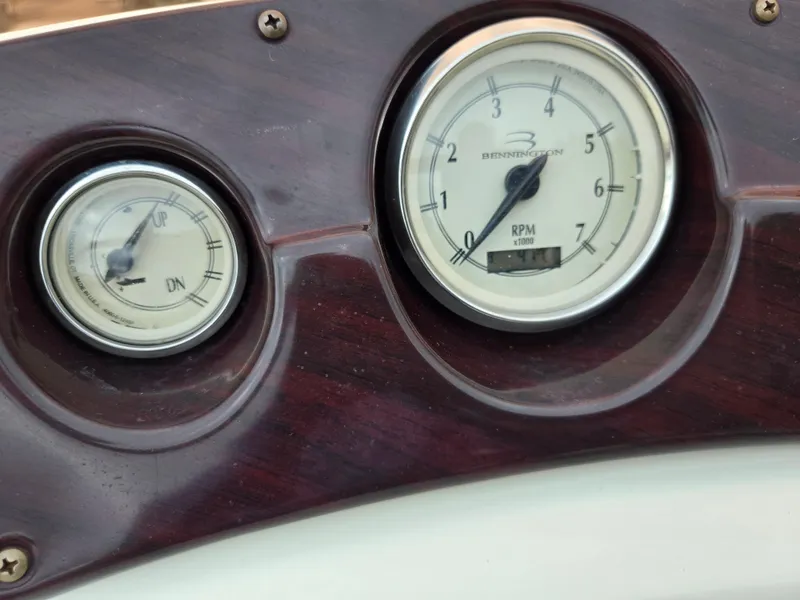 Slide: The Image of Dashboard gauges of a 2007 Bennington 2075GL boat, showing RPM and trim indicators. - 21