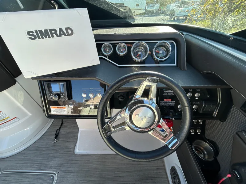 Slide: The Image of 2018 Sea Ray SLX 280 dashboard with steering wheel and Simrad navigation system. - 3