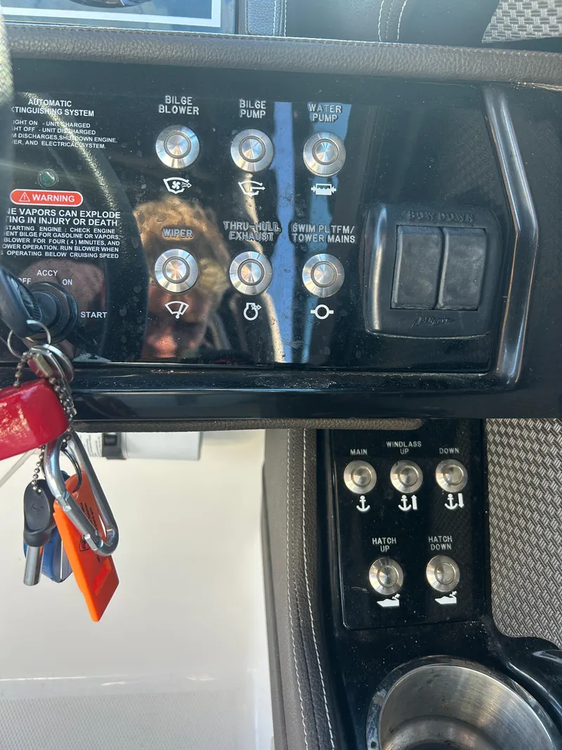 Slide: The Image of Control panel of a 2018 Sea Ray SLX 280 boat with various switches and keys. - 4