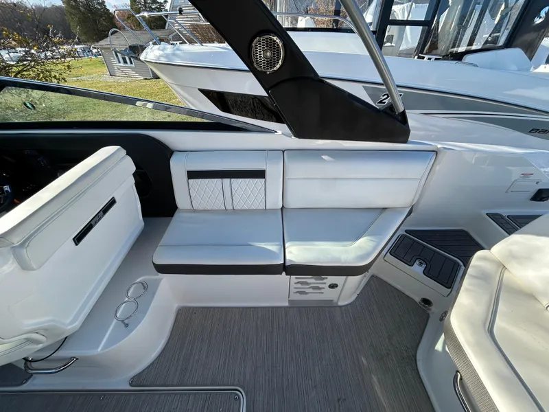 Slide: The Image of Interior seating of a 2018 Sea Ray SLX 280 boat, featuring white upholstery and modern design. - 6