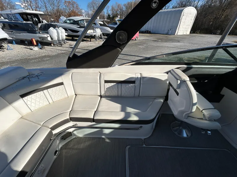 Slide: The Image of 2018 Sea Ray SLX 280 boat interior with white seating and modern design. - 7
