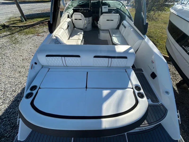 Slide: The Image of 2018 Sea Ray SLX 280 boat interior with white seating and cup holders. - 8