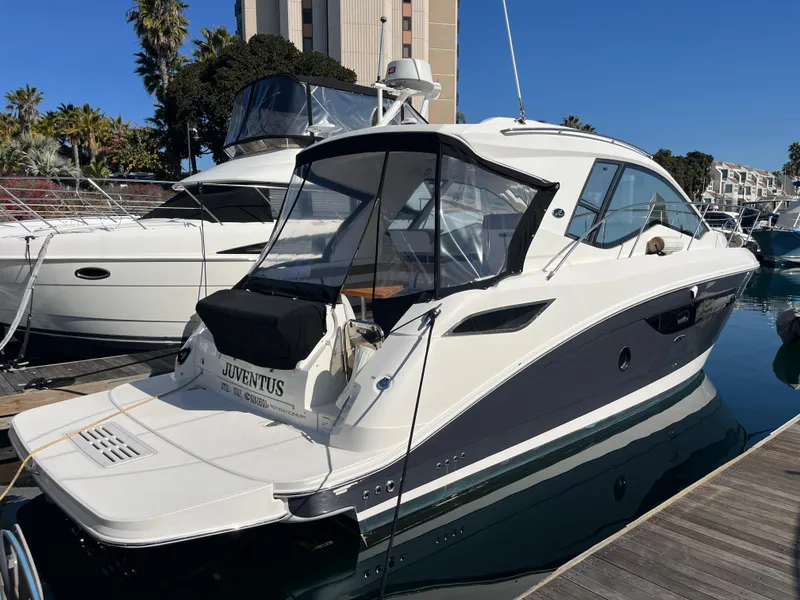 Slide: The Image of 2018 Sea Ray Sundancer 350 yacht docked at marina under clear blue sky. - 15