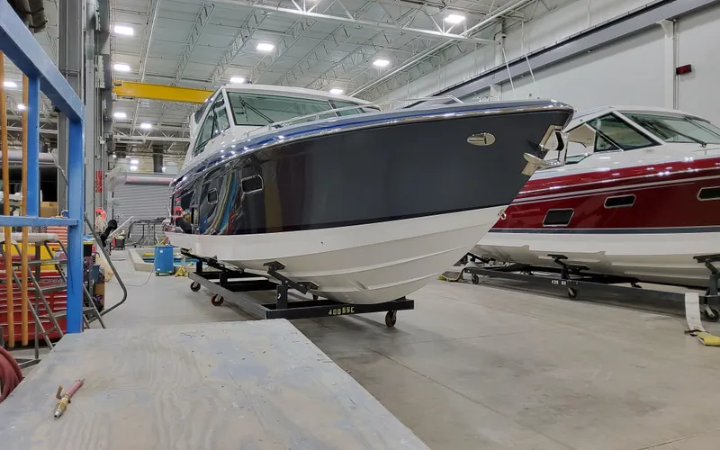 Slide: The Image of 2026 Formula 400 Super Sport Crossover boat in a workshop setting. - 2