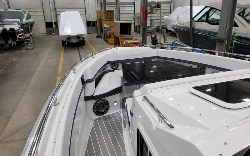 Slide: The Image of 2026 Formula 400 Super Sport Crossover boat interior in a warehouse setting. - 22