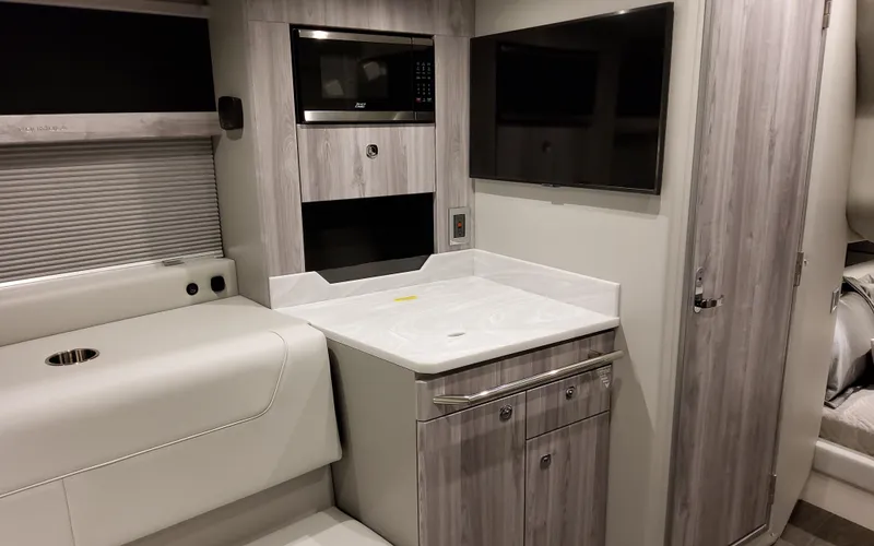 Slide: The Image of 2026 Formula 400 Super Sport Crossover interior with modern kitchenette and sleek design. - 32