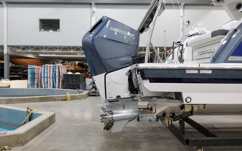 Slide: The Image of 2026 Formula 400 Super Sport Crossover with Mercury outboard engine in a workshop. - 5