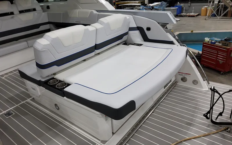 Slide: The Image of 2026 Formula 400 Super Sport Crossover boat interior with white seating and cup holders. - 9