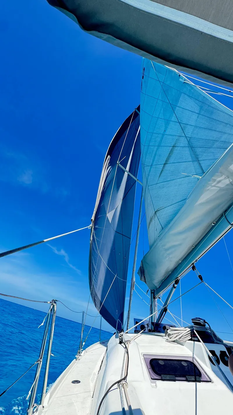 Slide: The Image of 2023 Beneteau Oceanis 34.1 sailing on clear blue waters under a bright sky. - 5