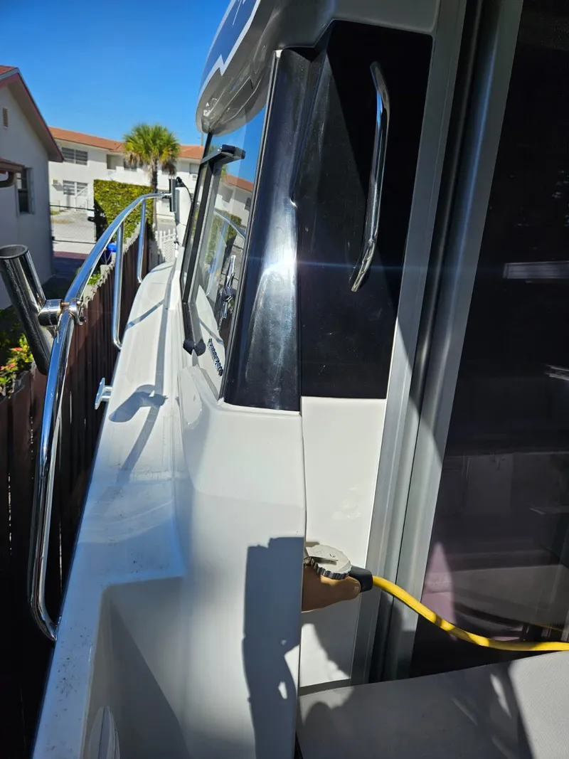 Slide: The Image of 2023 Jeanneau NC795 S2 boat side view with railing and power connection. - 10