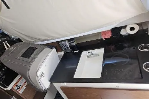 Slide: The Image of Interior of 2023 Jeanneau NC795 S2 boat with compact kitchen area. - 17