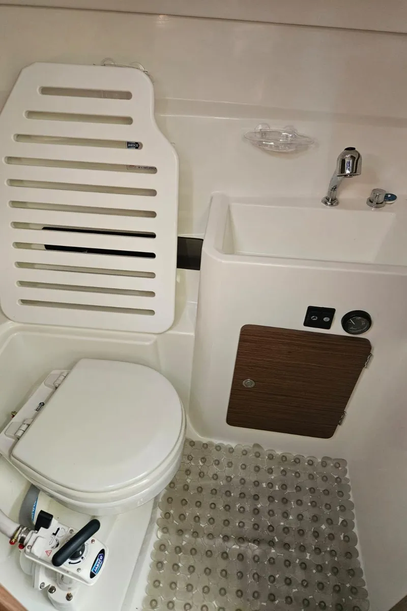 Slide: The Image of 2023 Jeanneau NC795 S2 boat bathroom with compact toilet and sink. - 26