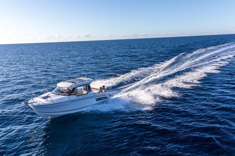 Slide: The Image of 2023 Jeanneau NC795 S2 boat cruising on open sea under clear blue sky. - 4