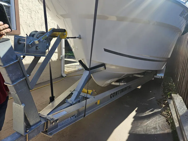 Slide: The Image of 2023 Jeanneau NC795 S2 boat on Continental trailer, parked outdoors. - 5