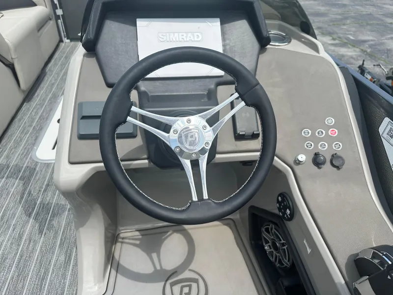 Slide: The Image of Steering wheel of 2023 Premier 250 Solaris boat with control panel and Simrad display. - 8