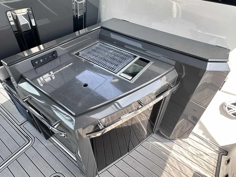 Slide: The Image of Outdoor kitchen on 2019 Cobalt A36 boat with sleek countertop and grill. - 12