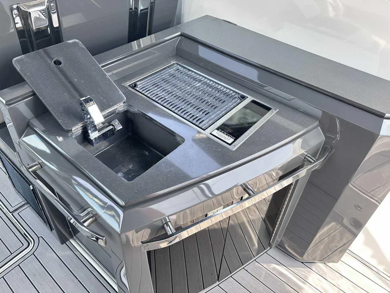 Slide: The Image of Outdoor kitchen setup on a 2019 Cobalt A36 boat, featuring a sink and grill. - 13