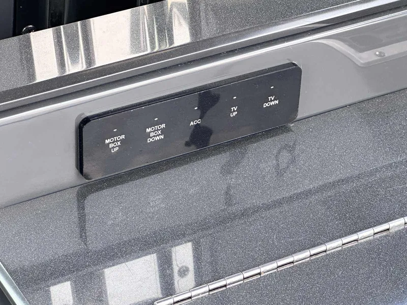 Slide: The Image of Control panel on a 2019 Cobalt A36 boat with motor and TV adjustments. - 14