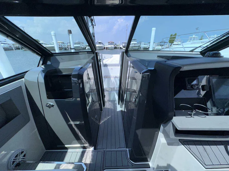 Slide: The Image of Interior view of a 2019 Cobalt A36 boat, showcasing sleek design and modern controls. - 28