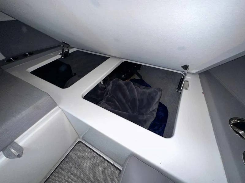 Slide: The Image of Interior storage compartment of a 2019 Cobalt A36 boat, featuring open hatches. - 33