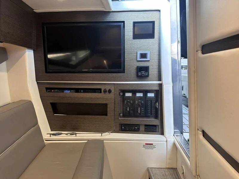 Slide: The Image of Interior of 2019 Cobalt A36 boat featuring a modern entertainment system and control panel. - 35