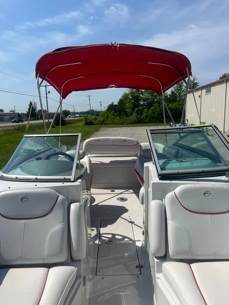 Slide: The Image of 2007 Crownline 220 EX boat with red canopy and white seating. - 4