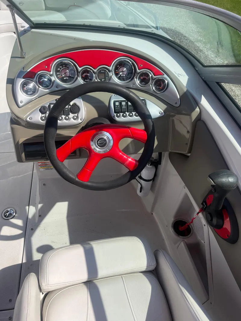Slide: The Image of 2007 Crownline 220 EX boat dashboard with red steering wheel and gauges. - 6