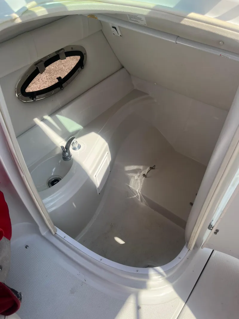 Slide: The Image of 2007 Crownline 220 EX boat interior with sink and porthole window. - 8