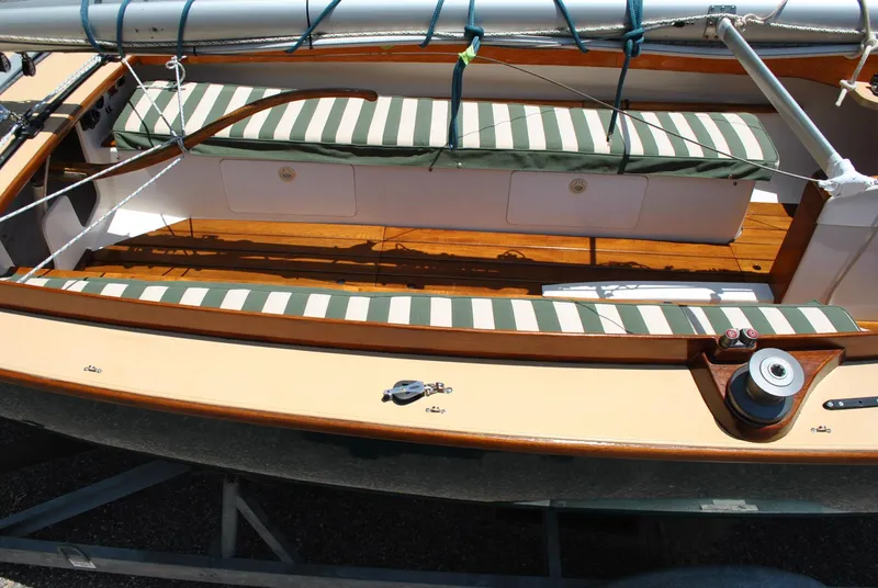 Slide: The Image of 2006 Edey & Duff Sakonnet 23 sailboat with striped cushions and wooden deck. - 11