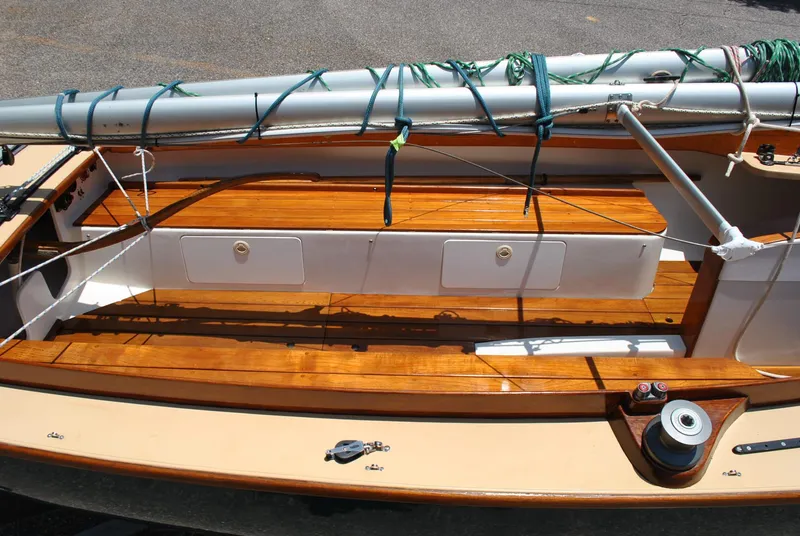 Slide: The Image of 2006 Edey & Duff Sakonnet 23 sailboat interior with wooden seating and mast. - 16