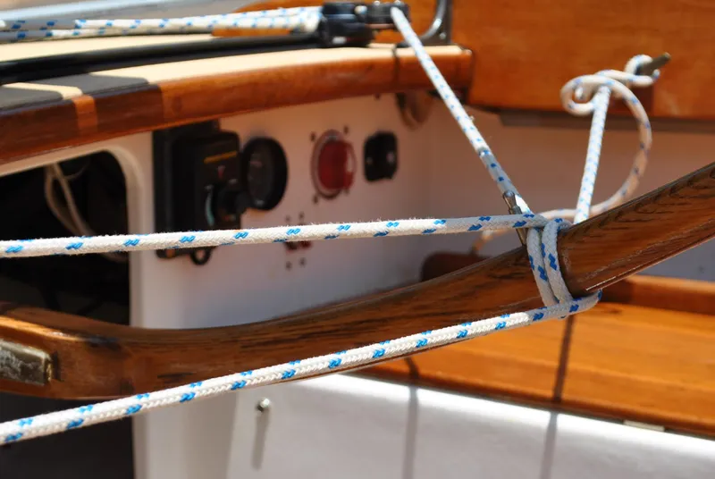 Slide: The Image of Close-up of 2006 Edey & Duff Sakonnet 23 sailboat rigging and wooden tiller. - 22