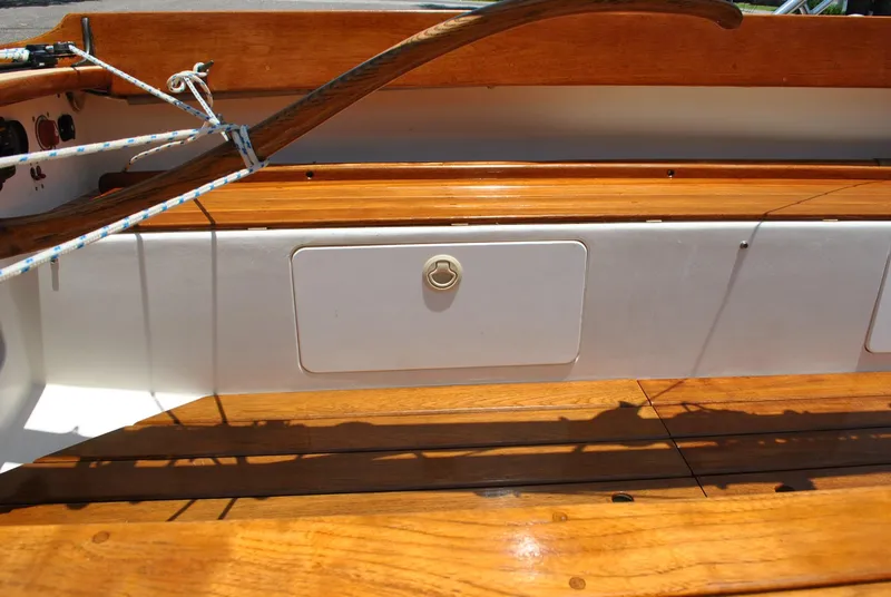 Slide: The Image of Interior of 2006 Edey & Duff Sakonnet 23 sailboat with wooden finish and storage compartment. - 26