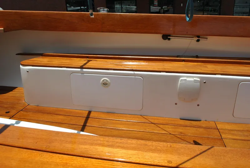 Slide: The Image of 2006 Edey & Duff Sakonnet 23 boat interior with polished wooden seating and storage compartments. - 28