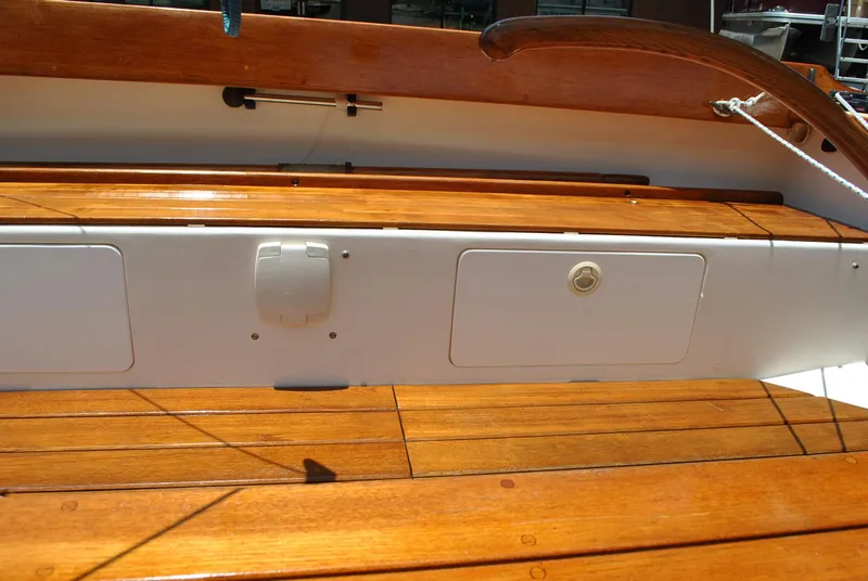 Slide: The Image of 2006 Edey & Duff Sakonnet 23 boat with polished wooden deck and white storage compartments. - 29