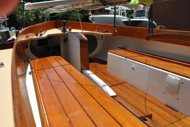 Slide: The Image of 2006 Edey & Duff Sakonnet 23 sailboat interior with polished wooden seating and storage compartments. - 30