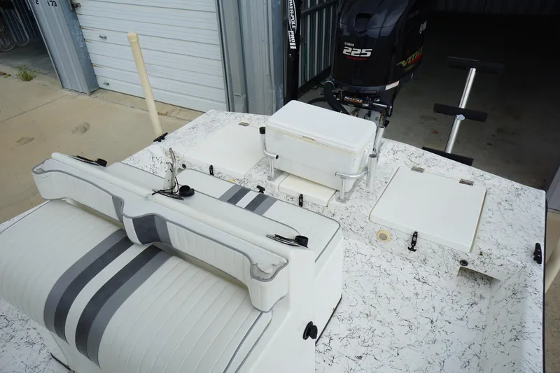 Slide: The Image of 2015 Desperado 22 Outlaw boat with Yamaha 225 engine, featuring white and gray seating. - 10