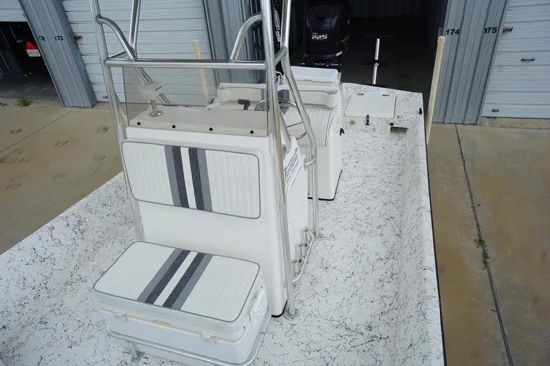 Slide: The Image of 2015 Desperado 22 Outlaw boat interior with striped seating and storage compartments. - 7
