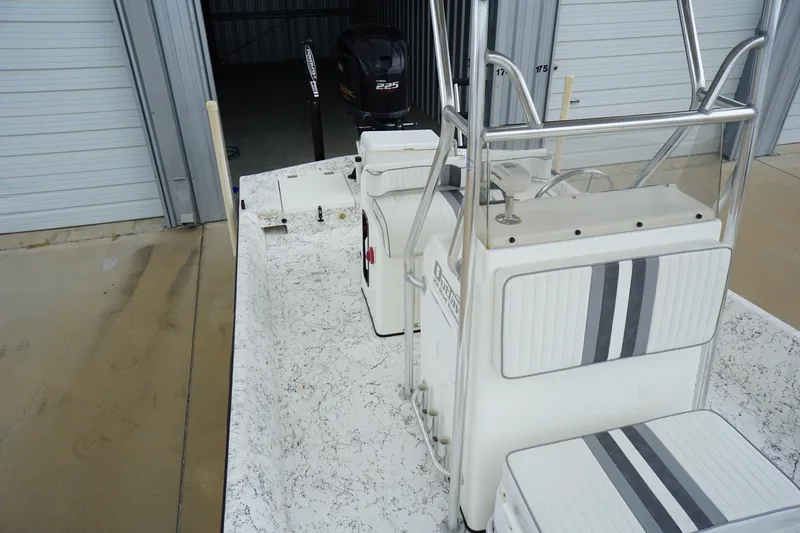 Slide: The Image of 2015 Desperado 22 Outlaw boat interior with striped seating and storage compartments. - 8