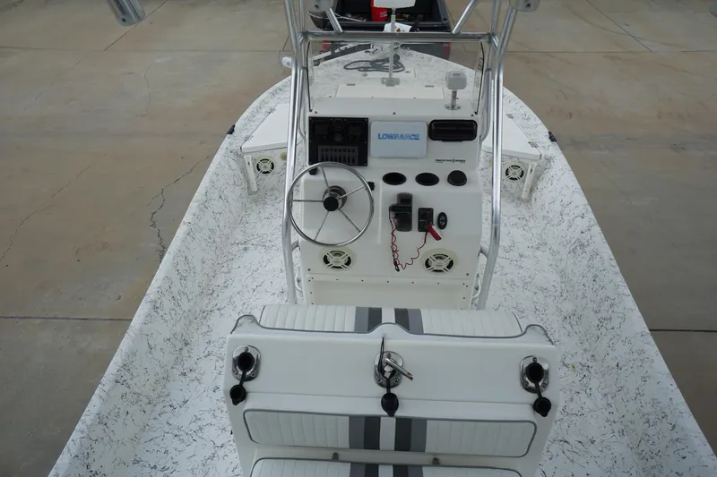 Slide: The Image of 2015 Desperado 22 Outlaw boat interior with steering console and seating. - 9