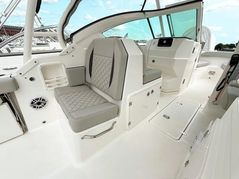 Slide: The Image of 2025 Pursuit DC 266 Dual Console interior with cushioned seating and modern design. - 10