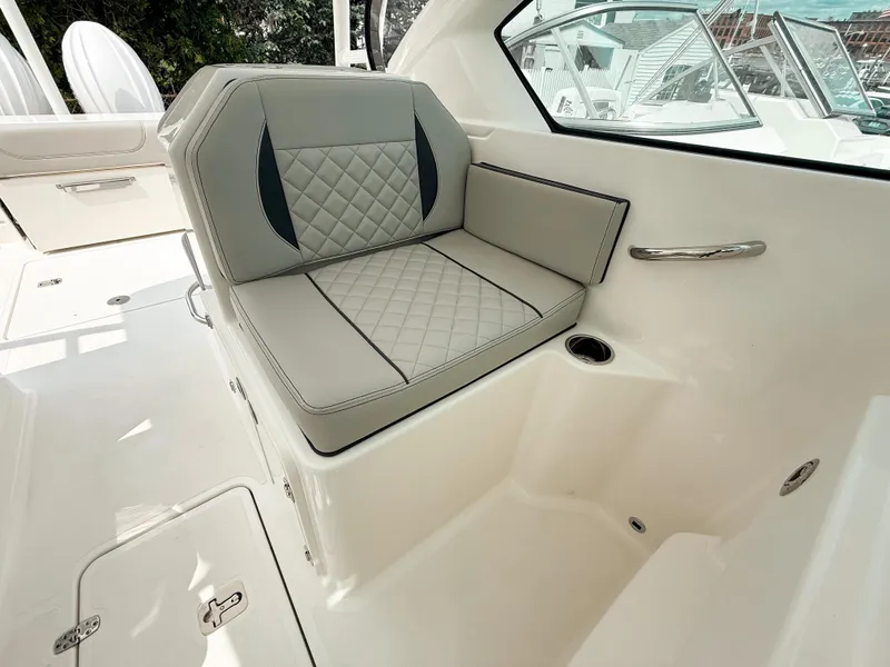 Slide: The Image of 2025 Pursuit DC 266 Dual Console boat interior with cushioned seating and sleek design. - 13