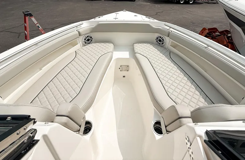 Slide: The Image of 2025 Pursuit DC 266 Dual Console boat interior with luxurious seating and speakers. - 15