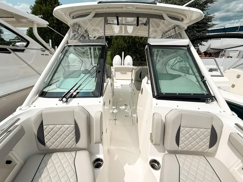 Slide: The Image of 2025 Pursuit DC 266 Dual Console boat interior with luxurious seating and modern design. - 16