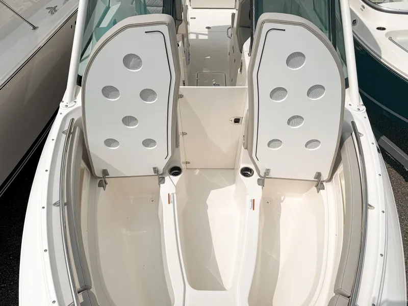 Slide: The Image of 2025 Pursuit DC 266 Dual Console boat interior with open storage compartments. - 19
