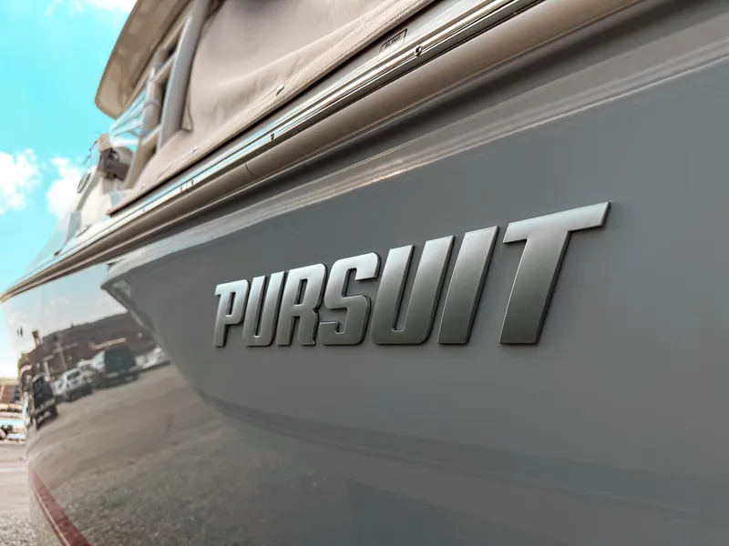 Slide: The Image of 2025 Pursuit DC 266 Dual Console boat with logo detail. - 4