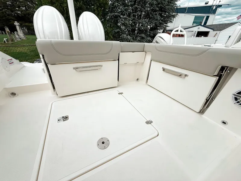 Slide: The Image of 2025 Pursuit DC 266 Dual Console boat interior with storage compartments and seating. - 6