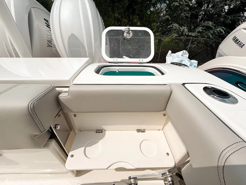 Slide: The Image of 2025 Pursuit DC 266 Dual Console boat interior with storage and seating area. - 8