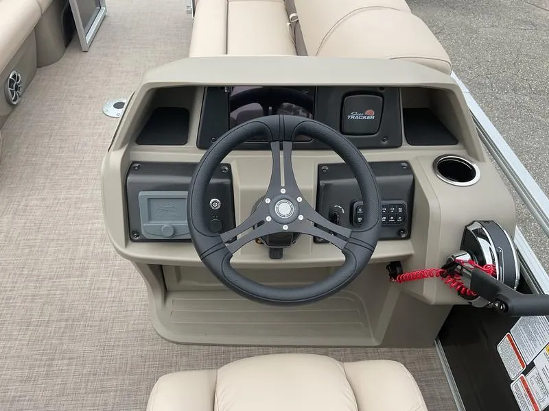 Slide: The Image of 2025 Sun Tracker PARTY BARGE® 22 DLX helm with steering wheel and control panel. - 8